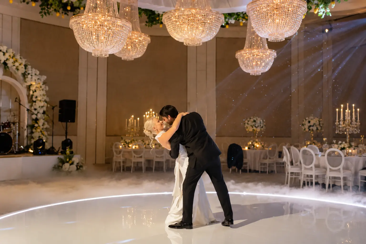 Punir and Marina sharing their first dance at their elegant Dubai wedding reception under crystal chandeliers and romantic lighting.